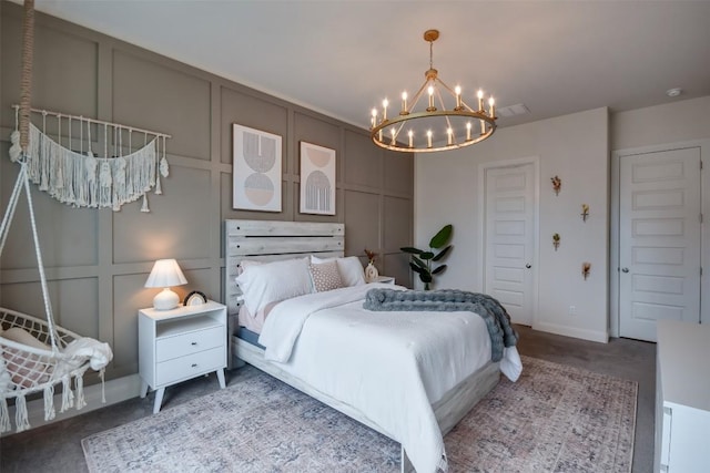 bedroom featuring a chandelier, carpet flooring, and a decorative wall