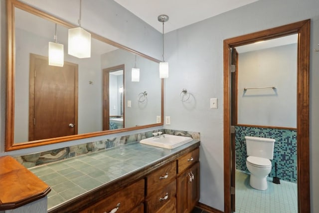 bathroom with tile patterned flooring, vanity, and toilet