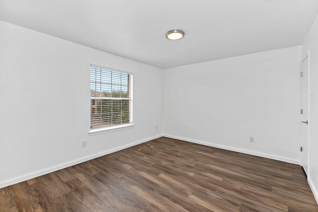 empty room with dark wood-type flooring