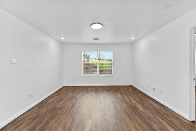 unfurnished room with dark hardwood / wood-style flooring