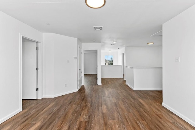 spare room featuring dark wood-type flooring