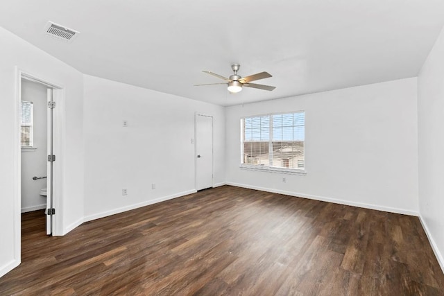 empty room featuring dark wood-type flooring and ceiling fan