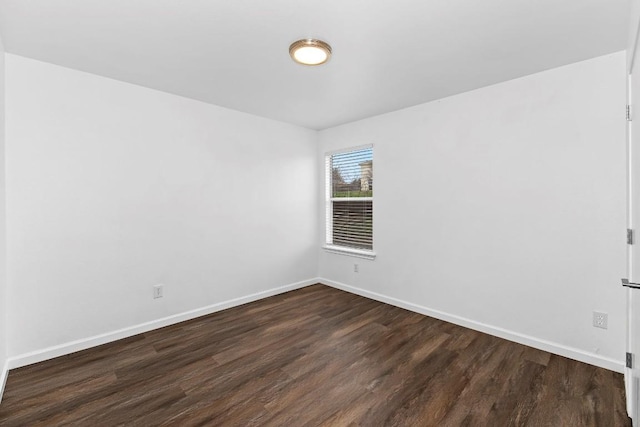 spare room featuring dark hardwood / wood-style flooring