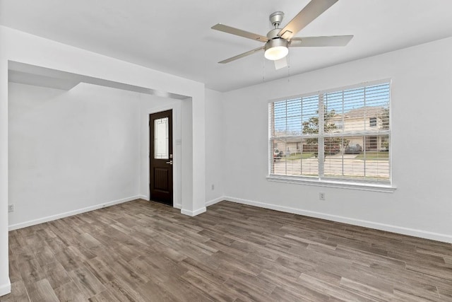 unfurnished room with hardwood / wood-style floors and ceiling fan