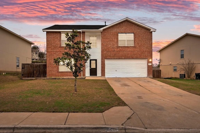 view of front of property with central AC, a garage, and a yard