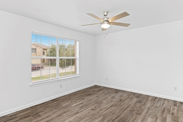 spare room featuring hardwood / wood-style flooring and ceiling fan