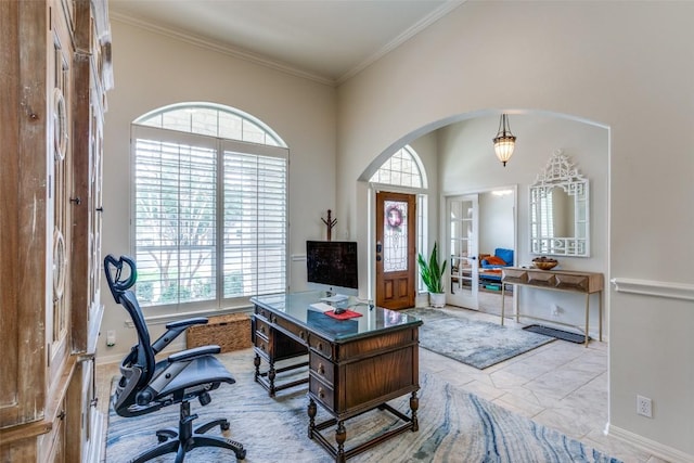 home office with ornamental molding, arched walkways, marble finish floor, and baseboards