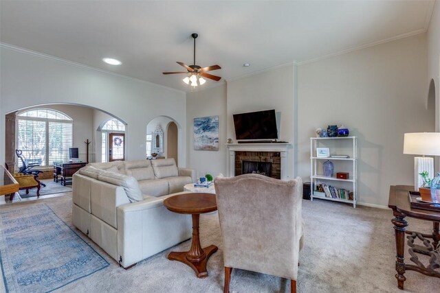 carpeted living room featuring ceiling fan and ornamental molding