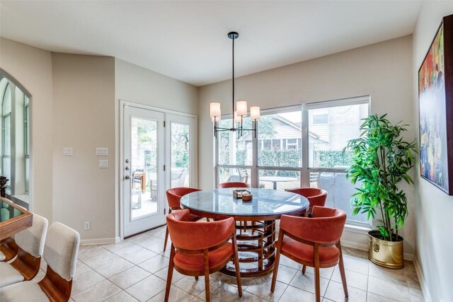 tiled dining area with an inviting chandelier