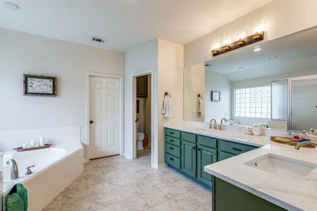 full bathroom featuring vanity, toilet, and independent shower and bath