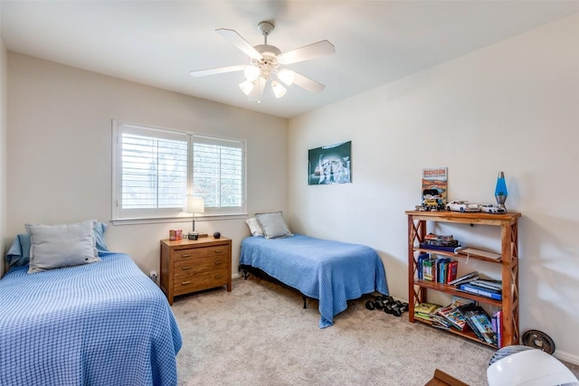 bedroom featuring ceiling fan and light carpet