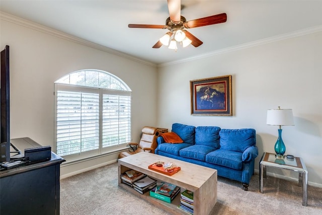 carpeted living room with crown molding, baseboards, and ceiling fan
