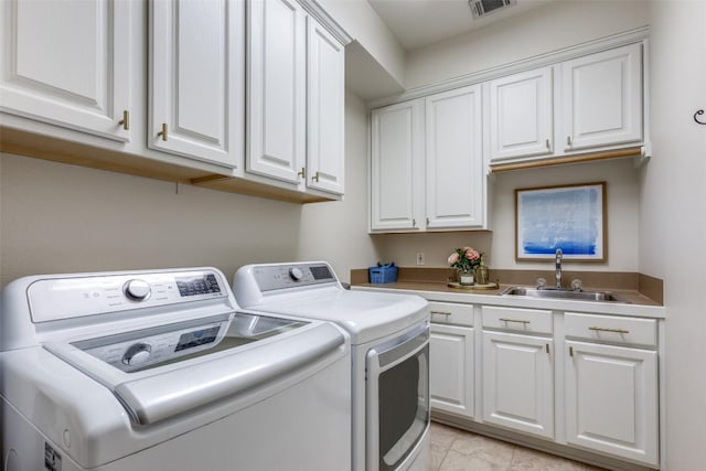 washroom featuring independent washer and dryer, visible vents, cabinet space, a sink, and light tile patterned flooring