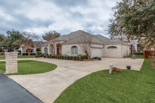 view of front of property with a garage and a front lawn