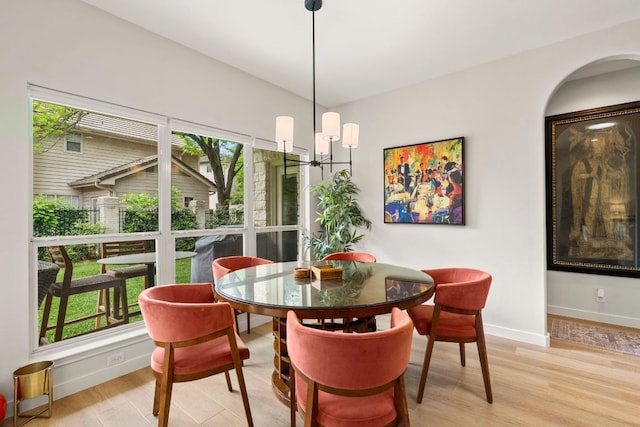 dining area featuring light wood-style floors and baseboards