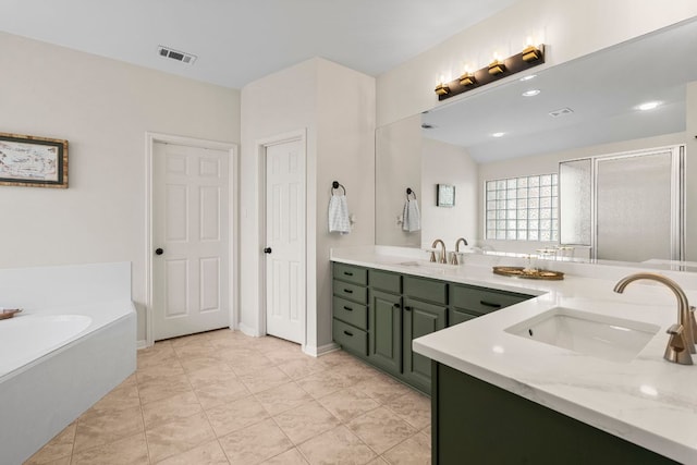 bathroom featuring visible vents, a sink, a garden tub, and double vanity