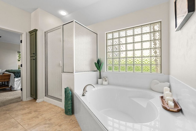 bathroom with a garden tub, tile patterned flooring, connected bathroom, and a stall shower