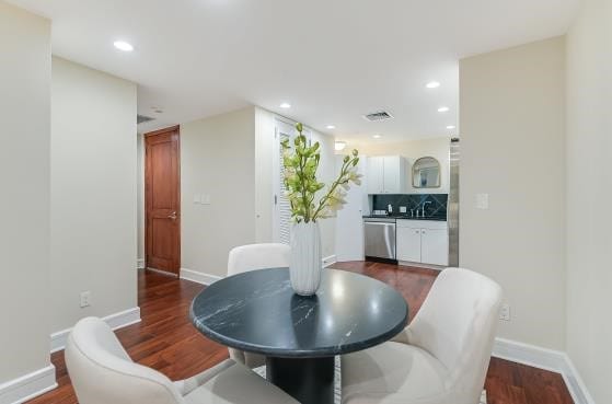 dining area featuring dark wood-style floors, baseboards, and recessed lighting