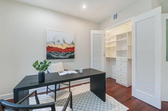 office space featuring baseboards, visible vents, dark wood-type flooring, and recessed lighting