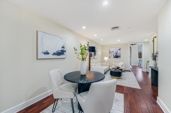 dining space featuring baseboards, visible vents, dark wood-type flooring, and recessed lighting