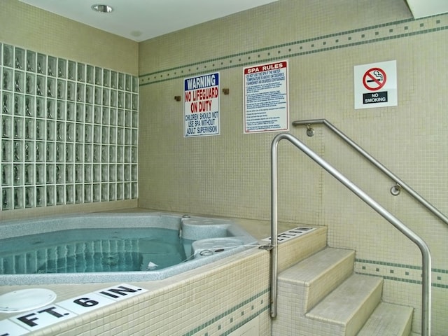 view of swimming pool with an indoor in ground hot tub