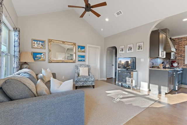 living room featuring ceiling fan and high vaulted ceiling