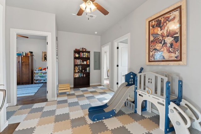 playroom with ceiling fan and electric panel