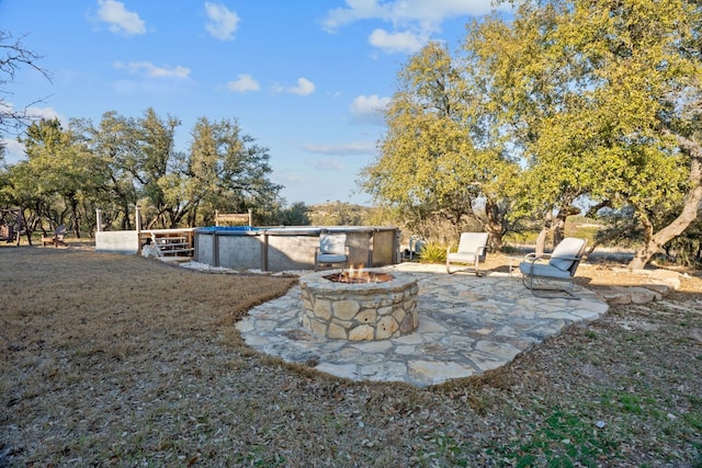 view of yard with a fire pit and a patio area