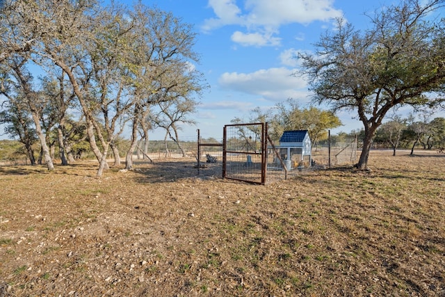 view of yard with a rural view and an outdoor structure