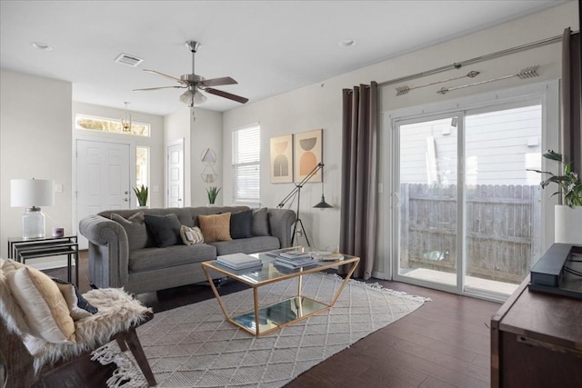 living room featuring ceiling fan and dark hardwood / wood-style floors