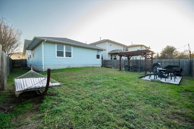 rear view of property featuring a patio, a yard, and a pergola