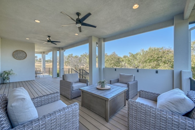 wooden deck featuring an outdoor hangout area and ceiling fan