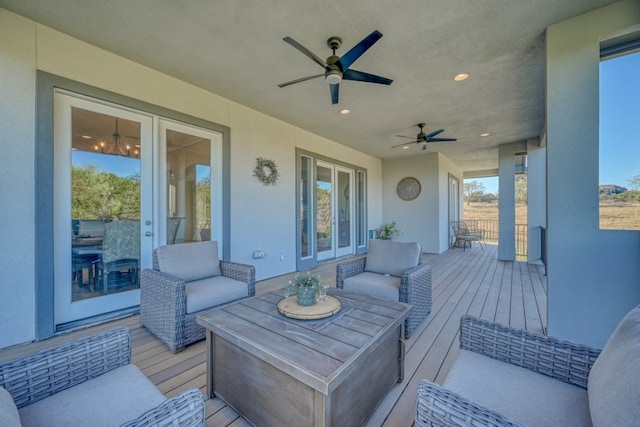 wooden terrace with ceiling fan and outdoor lounge area