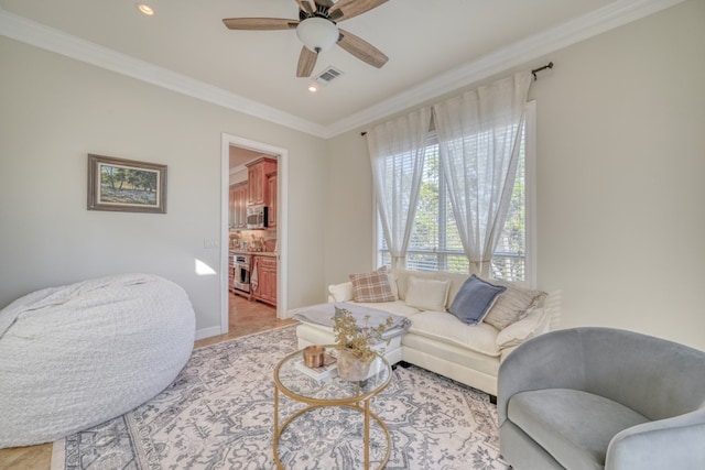 living room with ornamental molding and ceiling fan