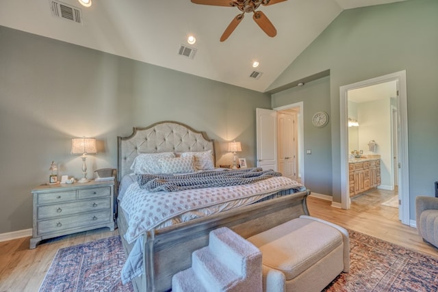 bedroom featuring high vaulted ceiling, ensuite bathroom, ceiling fan, and light wood-type flooring