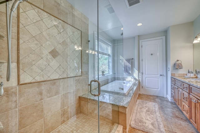 bathroom with vanity, independent shower and bath, and tile patterned flooring