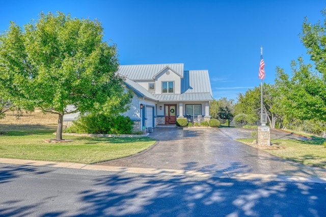 view of front of home with a garage and a front yard