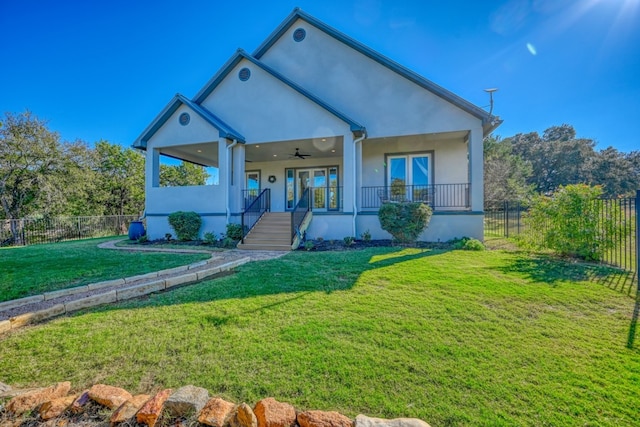 view of front of property with french doors, ceiling fan, covered porch, and a front lawn