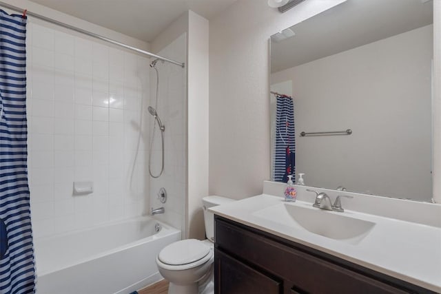 full bathroom with vanity, shower / bath combo, and toilet