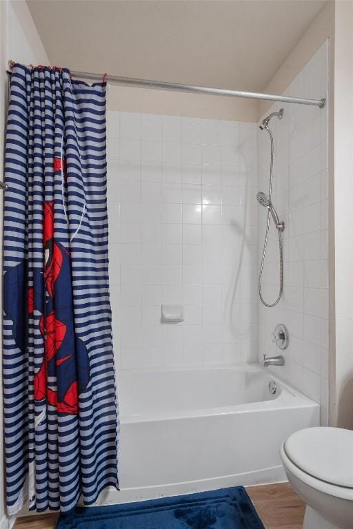 bathroom with hardwood / wood-style flooring, toilet, and shower / bath combination with curtain