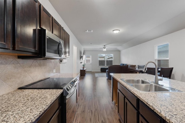 kitchen with sink, backsplash, stainless steel appliances, dark hardwood / wood-style floors, and dark brown cabinetry