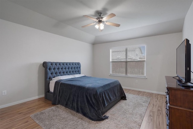 bedroom featuring ceiling fan, lofted ceiling, and light wood-type flooring