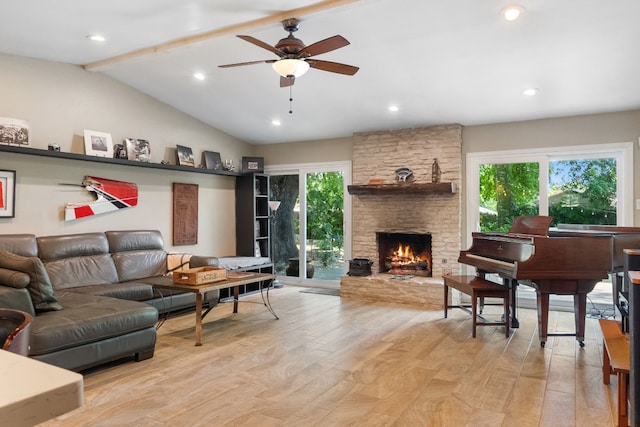 living room featuring a fireplace, light hardwood / wood-style flooring, lofted ceiling with beams, and ceiling fan