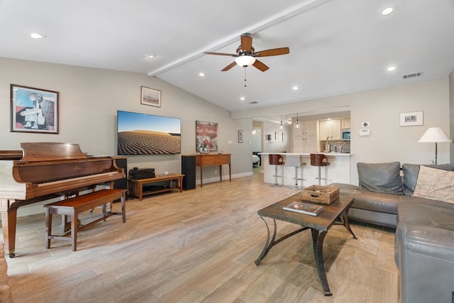 living room featuring lofted ceiling with beams, ceiling fan, and light hardwood / wood-style flooring