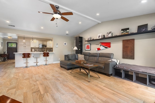 living room featuring ceiling fan, lofted ceiling with beams, and light hardwood / wood-style flooring