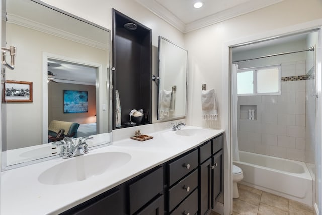 full bathroom featuring tiled shower / bath, vanity, toilet, crown molding, and tile patterned floors