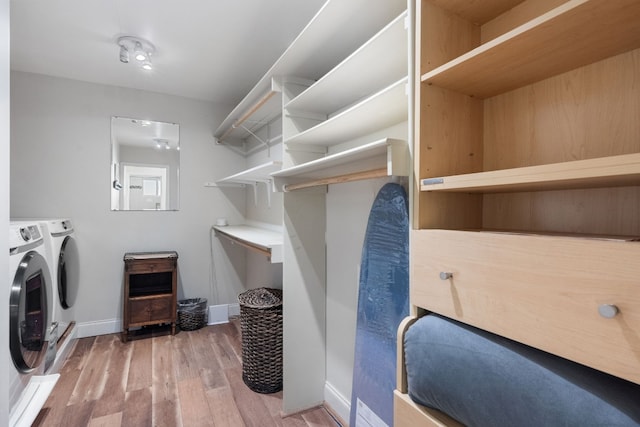 laundry room with wood-type flooring and washer and dryer