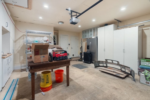 8406 Seminary Ridge Dr, Austin, TX 78745 - garage with stainless steel fridge, a garage door opener, and recessed lighting