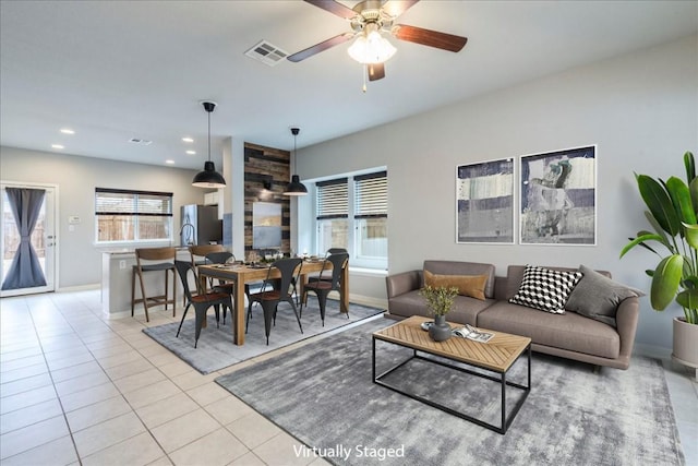 tiled living room with ceiling fan