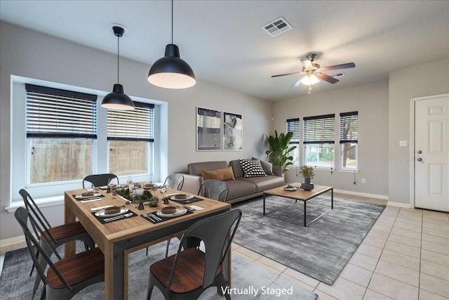 tiled dining area featuring ceiling fan